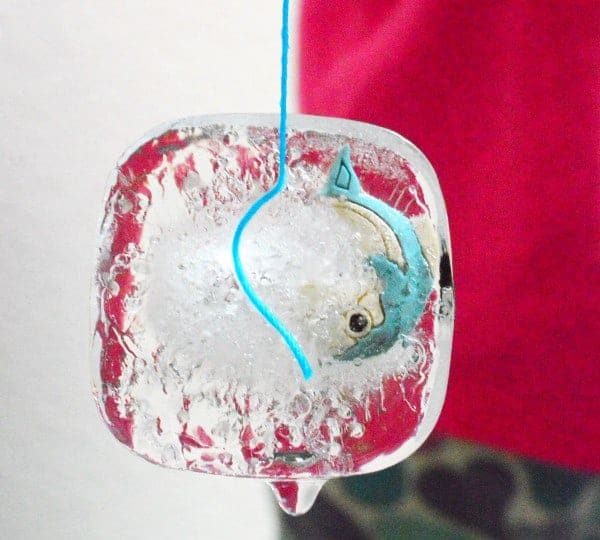 Fishing for a sticky ice cube using a twine