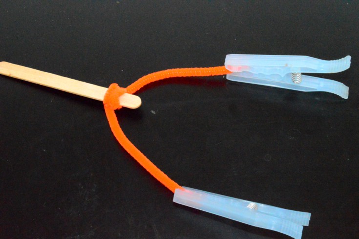 clothespins on both ends of the pipe cleaner to demonstrate center of gravity
