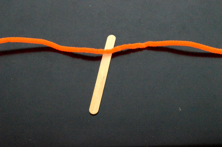 put pipe cleaner on top of the craft stick