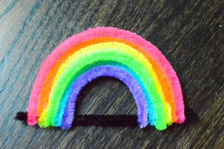 Bend the colored pipecleaners to make a rainbow as a base for growing crystals for kids.