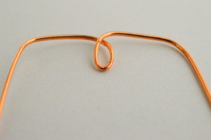 form a small loop using a copper wire