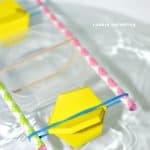 paddle boat made from pencil, foam shapes and rubber bands is placed in water
