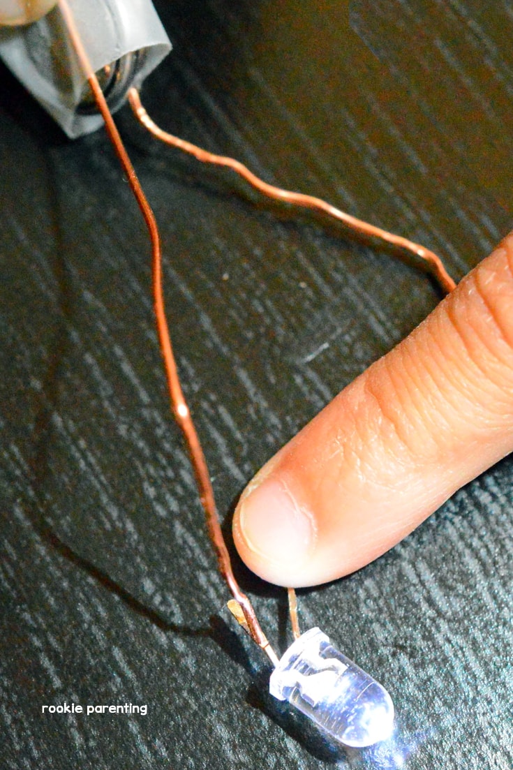 use a finger to press the copper wire and the LED light legs together if needed