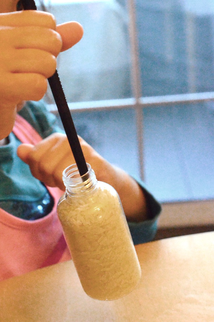 Lifting the chopstick lifts up the entire bottle of rice