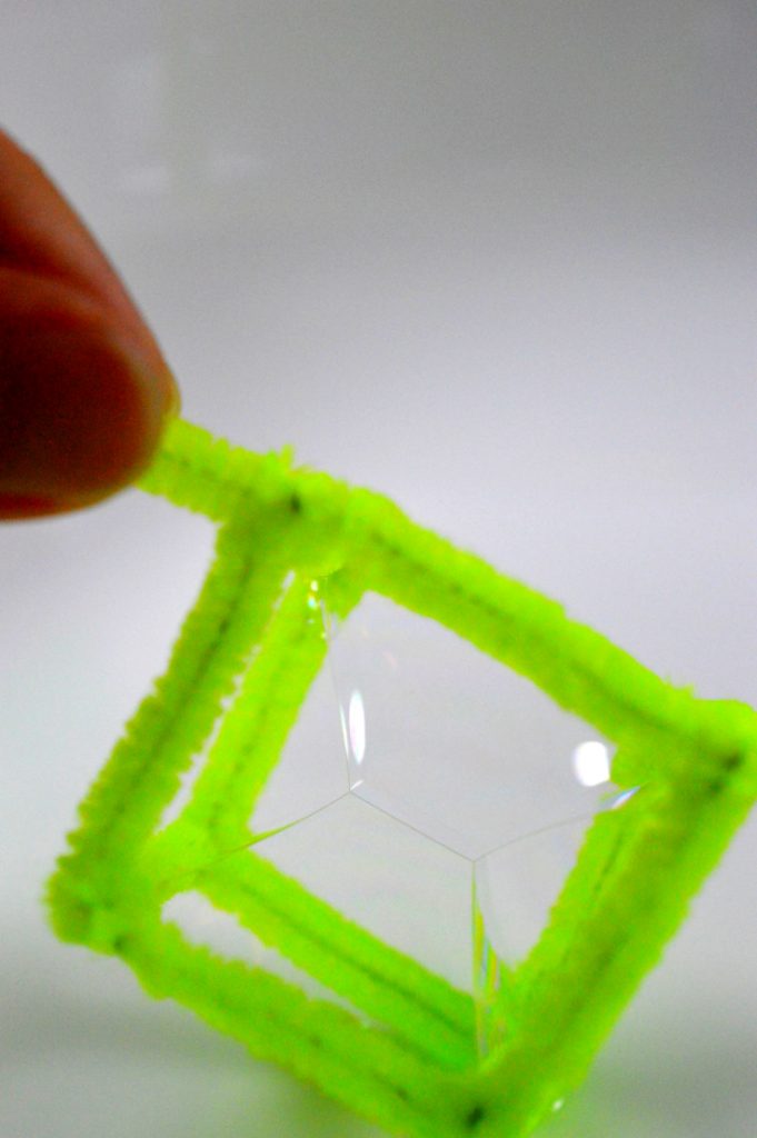 Green pipe-cleaner makes a square bubble.