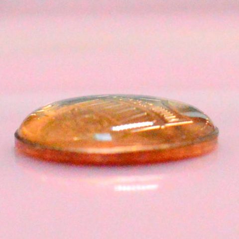 drops of water on top of penny form a dome shape
