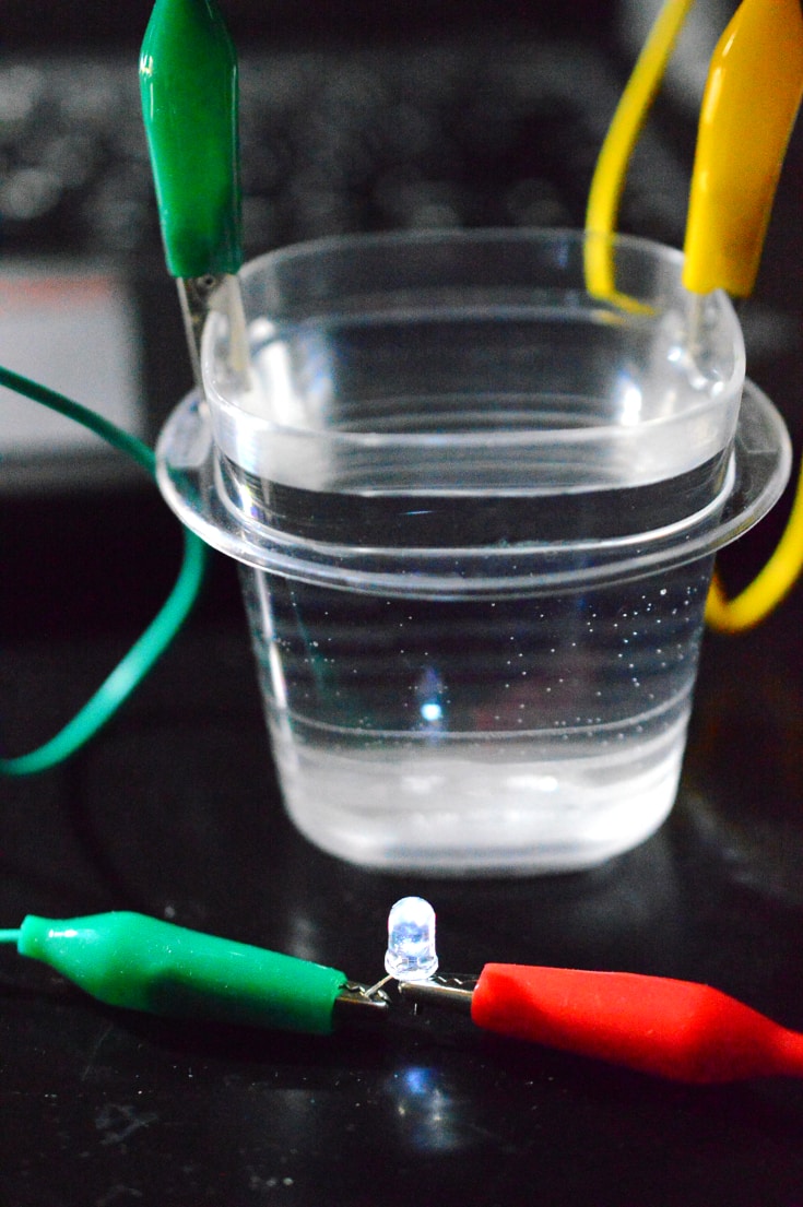Tap water can conduct electricity and the LED lights up